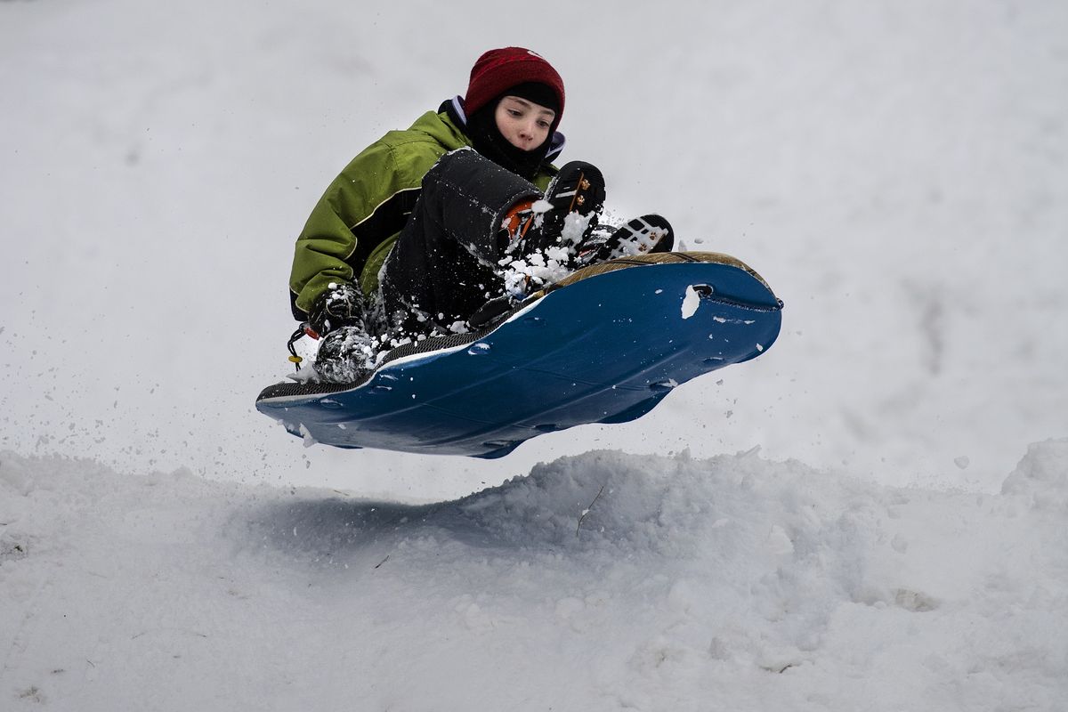 On a snow day from Hutton Elementary School, Caden Diamond, 11, goes airborne on his sled in Manito Park in January 2017.  (COLIN MULVANY/The Spokesman-Review)