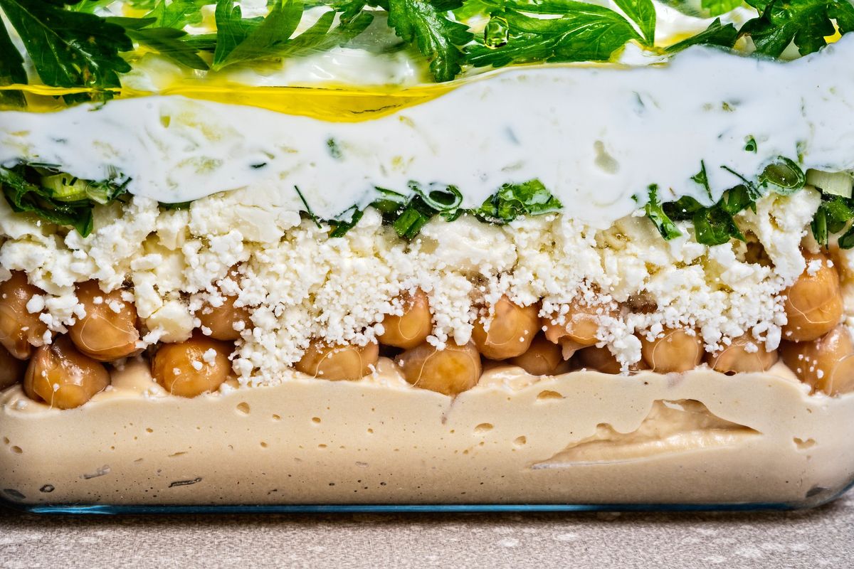 Mediterranean Five-Layer Dip  (Photo by Scott Suchman; food styling by Lisa Cherkasky/For the Washington Post)
