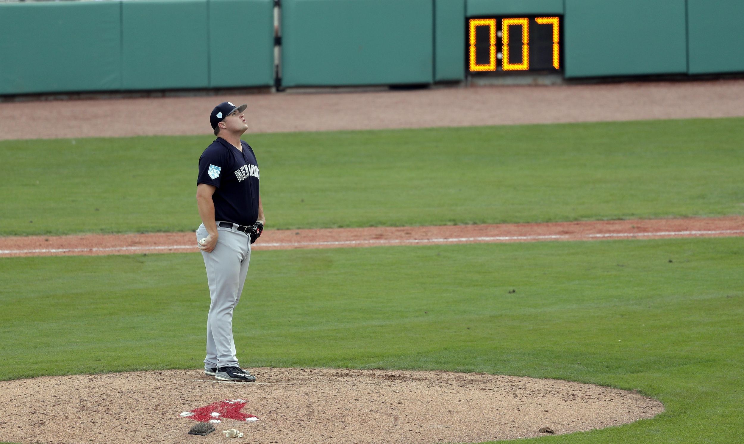 Slowly, baseball rolls out pitch clock in spring training The