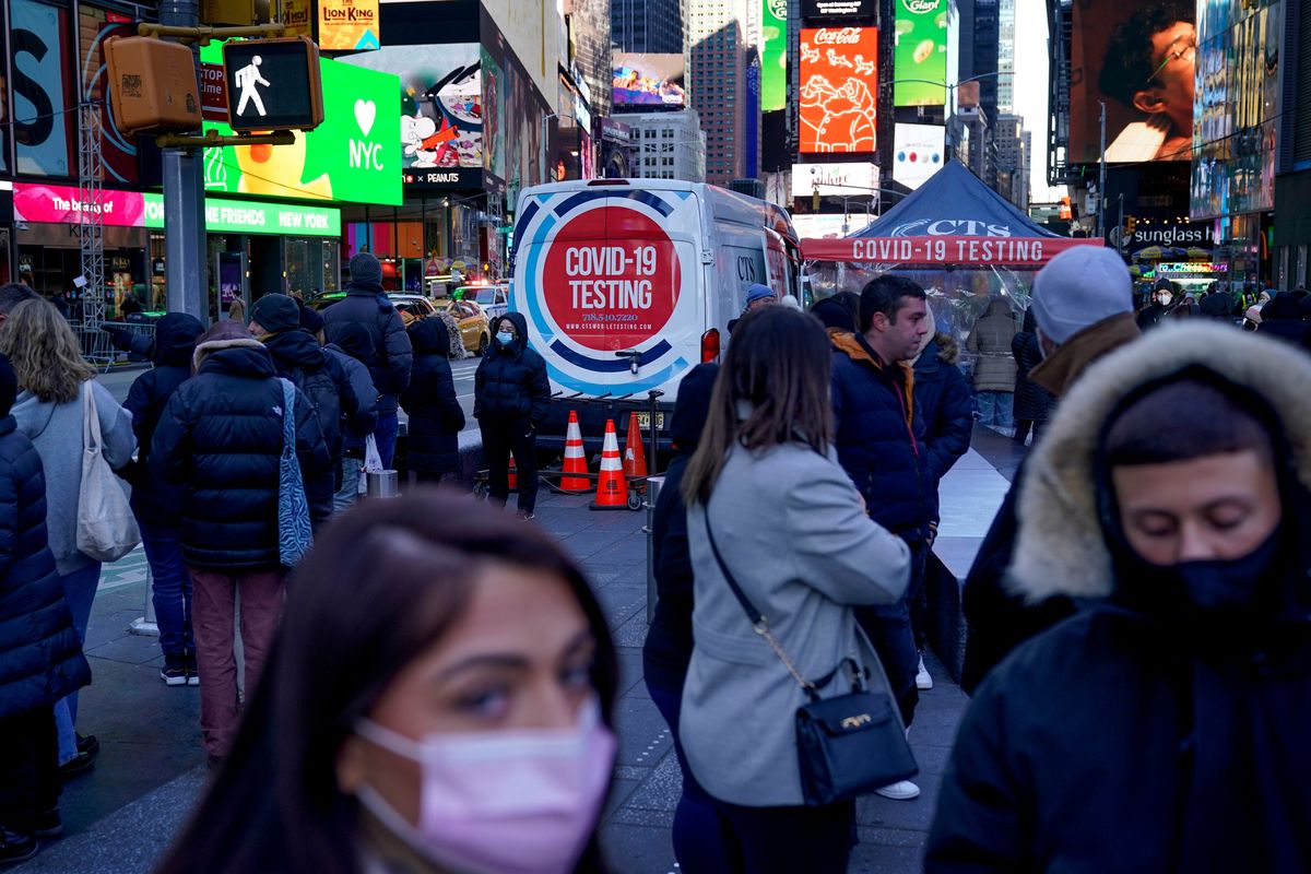 People wait in a long line on Dec. 20 to get tested for COVID-19 in Times Square, New York.  (Seth Wenig)