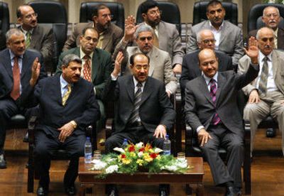 
Sunni Arab Deputy Prime Minister Salam Zikam Ali al-Zubaie, Shiite Prime Minister Nouri al-Maliki, and Kurd Deputy Prime Minister Barham Saleh, front row, from left, attend the inauguration of Iraq's new national government Saturday.
 (Associated Press / The Spokesman-Review)