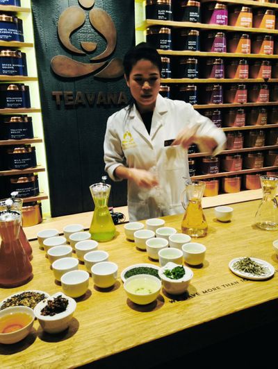 A Starbucks employee shows the Teavana “tea bar” in New York Wednesday. (Associated Press)