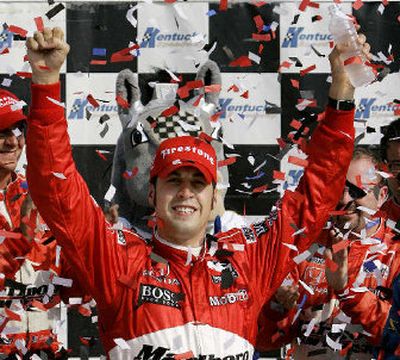 
Sam Hornish Jr. raises his arms in victory lane after winning the Meijer Indy 300 and taking back the points lead.
 (Associated Press / The Spokesman-Review)