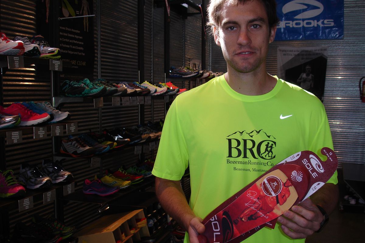 Adam Behrendt from Bozeman Running Company shows off a SOLE shoe, which includes an insert made from recycled cork and other materials. SOLE gathers natural wine stoppers from around the West and ships them to China, where they are ground and turned into other products.   (Jean Arthur / Down to EarthNW Correspondent)