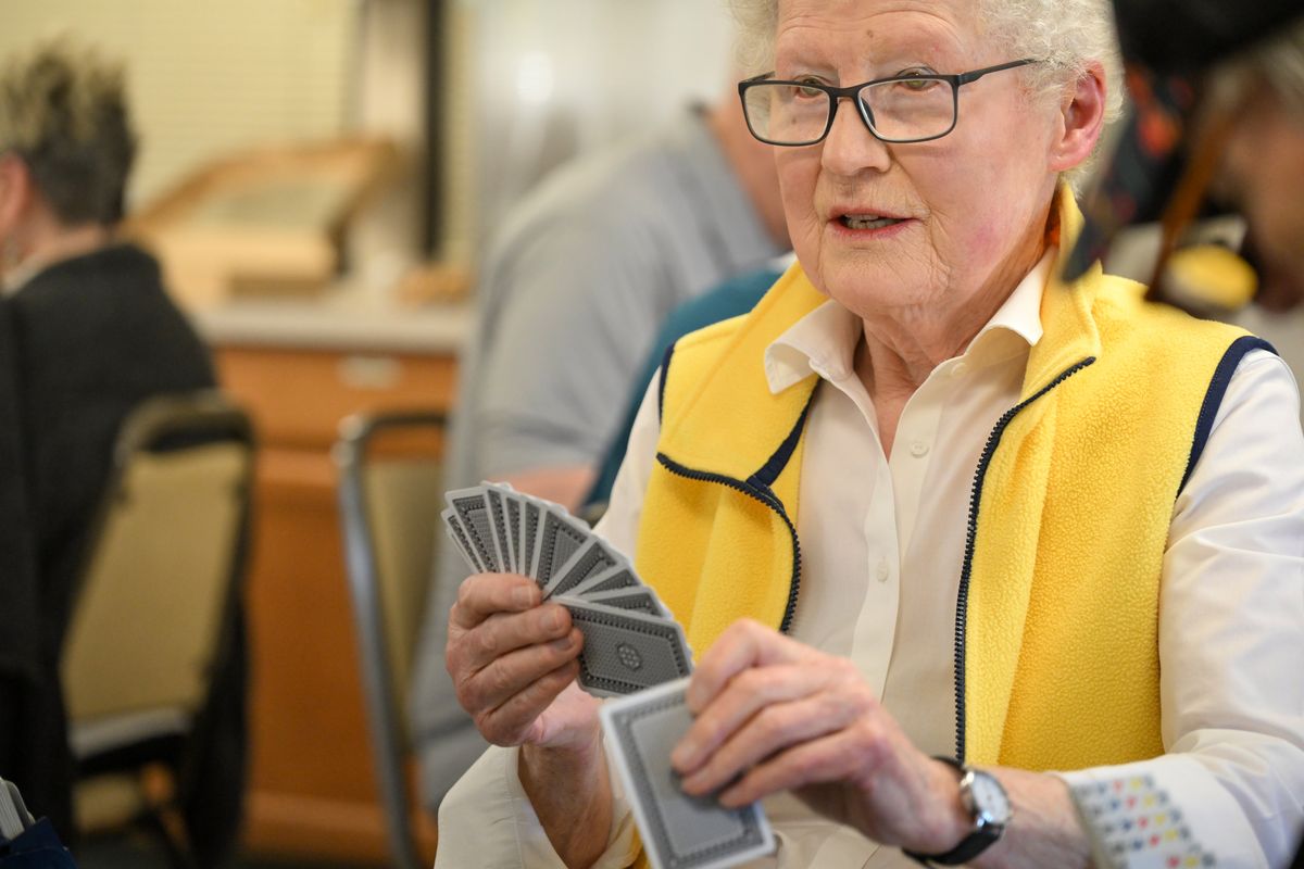 Catherine Geraghty watches her fellow players during a game of Bridge Friday, April 18, 2025 at the Spokane Duplicate Bridge Club at the Southside Community Center in Spokane, Washington. Bridge is a quiet game when played, but players watch each play carefully as each round plays out.  (Jesse Tinsley/THE SPOKESMAN-REVIEW)