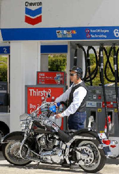 
Chevron employee Mario Ferrer gases up his motorcycle at a Chevron gas station near ChevronTexaco headquarters in San Ramon, Calif. 
 (Associated Press / The Spokesman-Review)