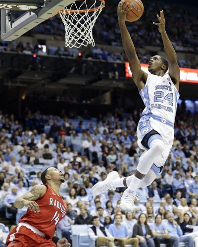 North Carolina's Kenny Williams, right, drives to the basket as Radford's Justin Cousin defends during the first half of an NCAA college basketball game in Chapel Hill, North Carolina, Sunday, Dec. 4, 2016. (Gerry Broome / Associated Press)