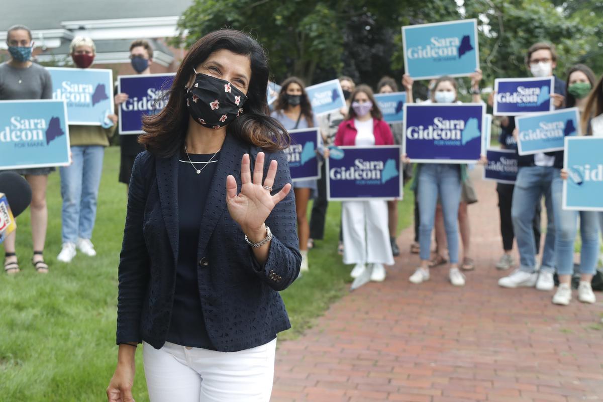House Speaker Sara Gideon, D-Freeport, greets news media near a polling station, Tuesday, July 14, 2020, in Portland, Maine. Gideon is one of three Democrat candidates seeking the party