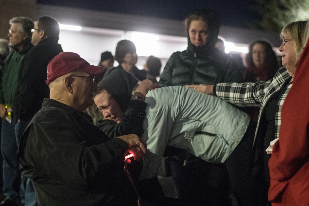 Regina Snider, a childhood friend of McCluskey, hugs Joyce Rudeen, McCluskey’s grandma, Wednesday during a vigil at Pullman High School’s track. “She was my best friend,” said Snider while holding back tears. (Luke Hollister / For The Spokesman-Review)