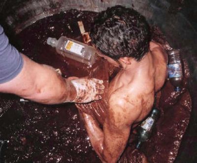
Rescuers try to help Darmin Garcia, an employee of a company that supplies chocolate ingredients, out of a vat of dark chocolate at Debelis Corp. in Kenosha, Wis., on Friday.
 (Associated Press / The Spokesman-Review)