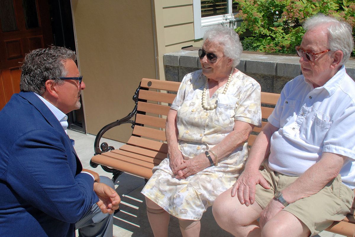 Dwayne Clark, CEO and founder of Aegis Living, chats with residents Frank and Ingeborg Detterbeck at Aegis of Bellevue. (TONY WADDEN)