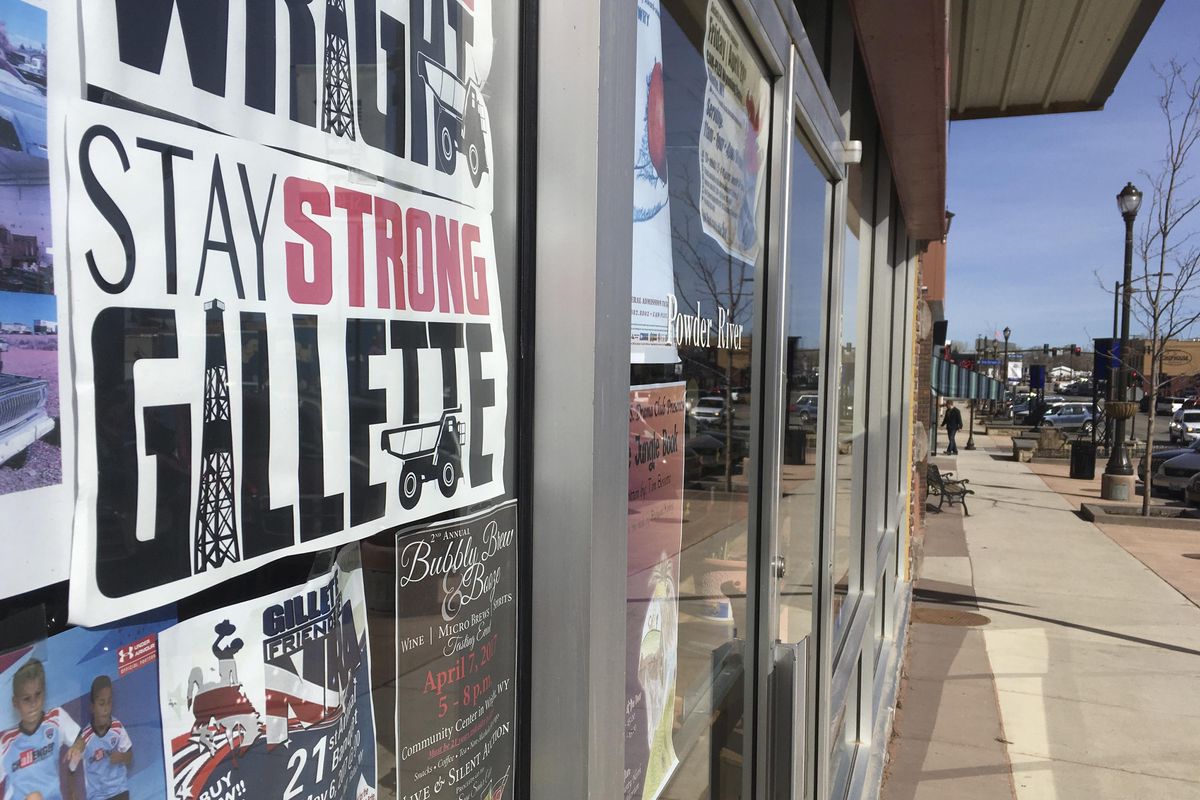 A sign in the door of a business in downtown Gillette, Wyoming calls for strength amid hard times in the top coal-producing region in the U.S. Many locals say after 500 coal-mine layoffs and the industry