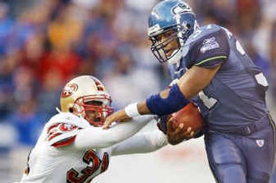 
Seattle running back Shaun Alexander, eluding 49ers safety Zach Bronson, ran for 77 yards on 22 carries in last year's 20-19 win over San Francisco in Seattle.
 (Associated Press / The Spokesman-Review)