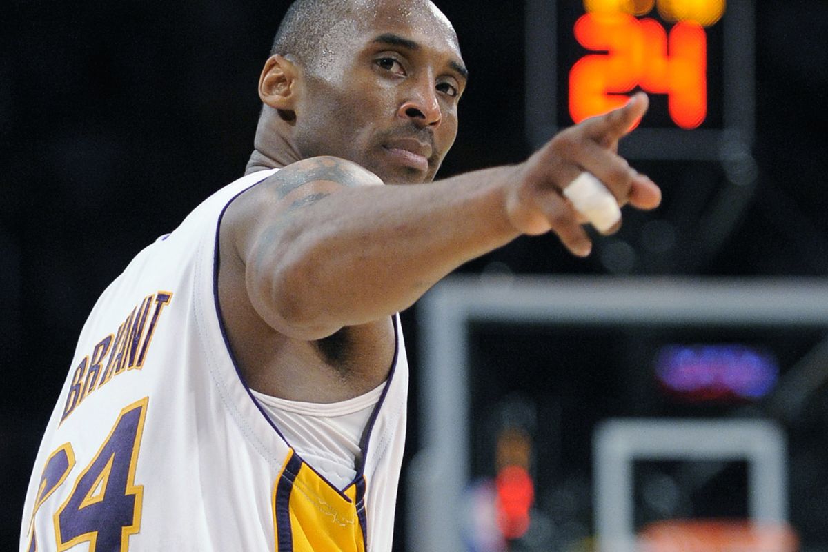 FILE - In this June 7, 2009, file photo, Los Angeles Lakers guard Kobe Bryant (24) points to a player behind him after making a basket in the closing seconds against the Orlando Magic in Game 2 of the NBA basketball finals in Los Angeles. Federal safety officials are expected to vote Tuesday, Feb. 9, 2021, on what likely caused the helicopter carrying Kobe Bryant, his 13-year-old daughter and seven others to crash into a Southern California hillside last year, killing all aboard.  (Mark J. Terrill)