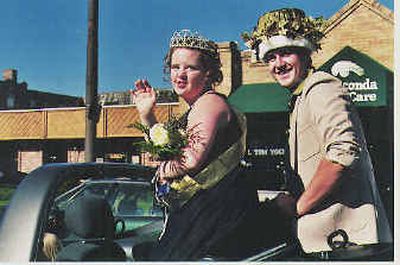 
Homecoming queen Amy Cozby, left, and king Zach Parks ride in a convertible during the homecoming parade Friday in Anaconda, Mont. Cozby is a 19-year-old senior with Down syndrome.
 (Associated Press / The Spokesman-Review)