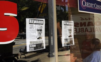 Reward posters hang in the window of a business in Gaffney, S.C., on Friday. Officials are looking for a serial killer blamed for four deaths over six days.  (Associated Press / The Spokesman-Review)