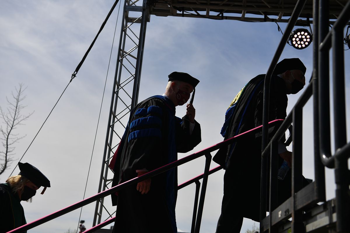 Daryll B. DeWald, chancellor of WSU Spokane, holds his tassel against the wind during the the Elson S. Floyd College of Medicine’s graduation ceremony on Thursday in Spokane.  (Tyler Tjomsland/The Spokesman-Review)