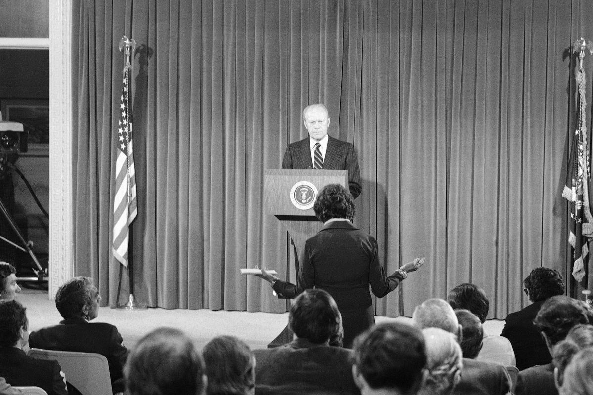 FILE - In this Oct. 9, 1975, file photo President Gerald Ford listens to a news reporter