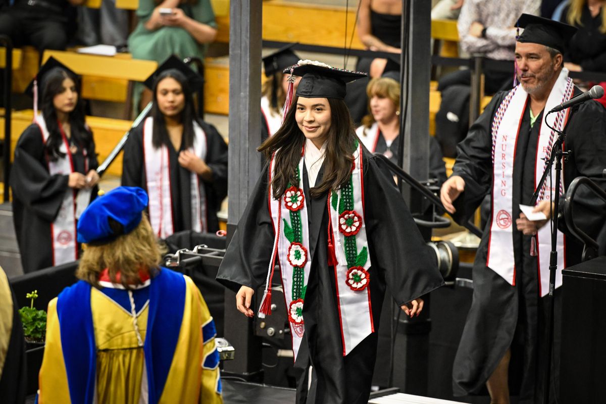 Alexana Bueno crosses the stage to receive her nursing degree diploma Friday at Reese Court at Eastern Washington University. She is a member of Eastern’s first graduating class in the Bachelor of Science in nursing. (Jesse Tinsley/THE SPOKESMAN-REVI)