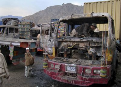 A Pakistani driver examines the burned cabin of a truck torched by militants on the outskirts of Landi Kotal, a town close to the Pakistani tribal area Khyber, on Wednesday.  (Associated Press / The Spokesman-Review)