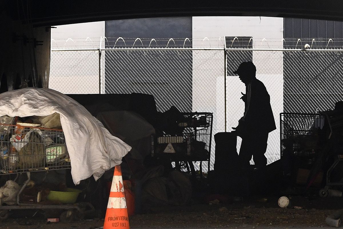In this May 21, 2020 photo, a man is seen at a homeless encampment that sits under Interstate 110 near Ramirez Street during the coronavirus outbreak in downtown Los Angeles. The number of homeless people counted across Los Angeles County jumped 12.7% over the past year to more than 66,400, according to data released Friday, June 12, by the Los Angeles Homeless Services Authority. Authorities fear that figure will spike again once the full impact of the coronavirus pandemic is felt.  (Mark J. Terrill)