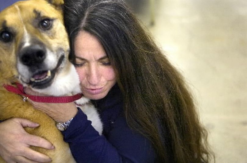 Patricia Simonet hugs Adam the dog at Spokane Regional Animal Protection Services (SCRAPS) Tuesday afternoon, December 6, 2005. Simonet recorded dog laughter and found that the sound calms the animals at the shelter. Holly Pickett/The Spokesman-Review
