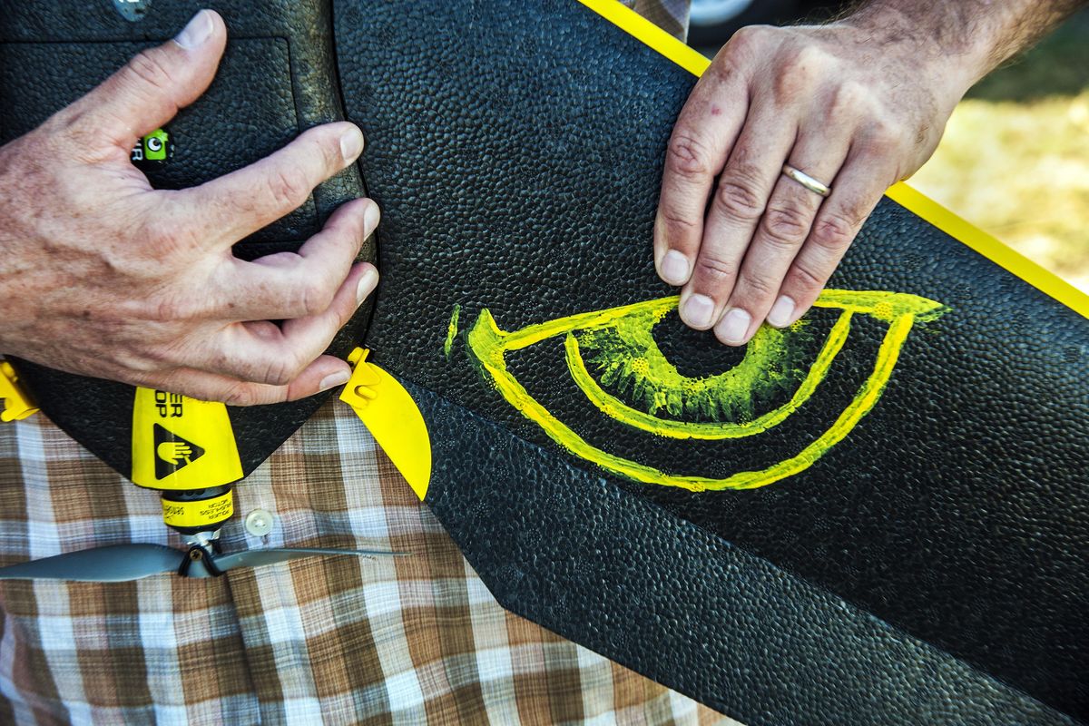 Brad Ward of Coeur d’Alene-based Empire Unmanned breaks down his drone with a 38-inch wingspan on Five Mile Prairie in Spokane. His daughter painted a set of eyes on the wings to scare off eagles, falcons and hawks tempted to attack the aircraft. (Dan Pelle / The Spokesman-Review)