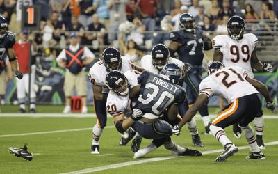 Justin Forsett, center, piled up 136 rushing yards in the second half of the Seahawks’ win over Chicago on Saturday. (Associated Press / The Spokesman-Review)