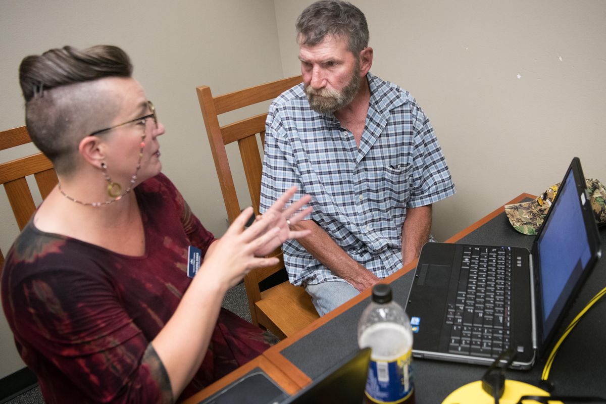 Brianna Dirks, an instructor for Community Colleges of Spokane, gives Jerry Kane pointers before he took a GED test Wednesday, July 25, 2018, at the Deer Park Library in Deer Park, Wash. Kane dropped out of high school at 17. He earned his GED at 61, thanks to a program from Spokane County Library District and the Community Colleges of Spokane Adult Education Department to bring courses to libraries for anyone looking to earn a high school diploma, get a GED, and learn English as their second language. (Tyler Tjomsland / The Spokesman-Review)