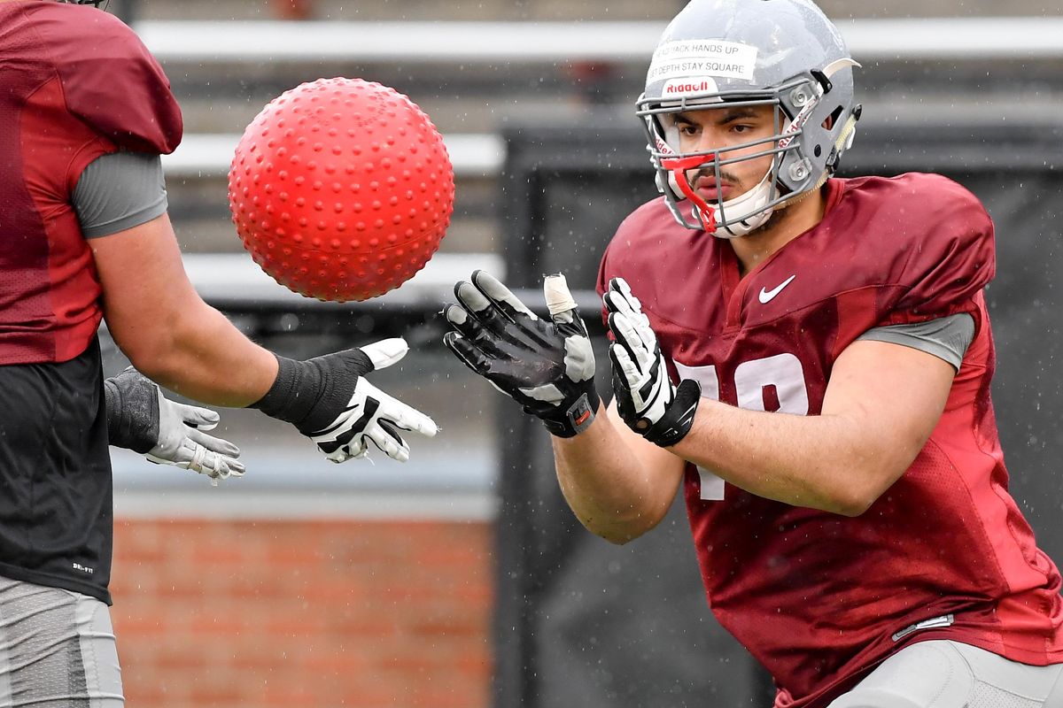 Washington State’s Abraham Lucas  runs through drills with fellow offensive linemen during a spring practice Thursday at Martin Stadium in Pullman. (Tyler Tjomsland / The Spokesman-Review)