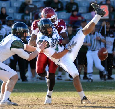 Hawaii’s Mana Silva, front center, makes an unsuccessful attempt to intercept the ball against New Mexico State in Hawaii’s 59-24 win.  (Associated Press)