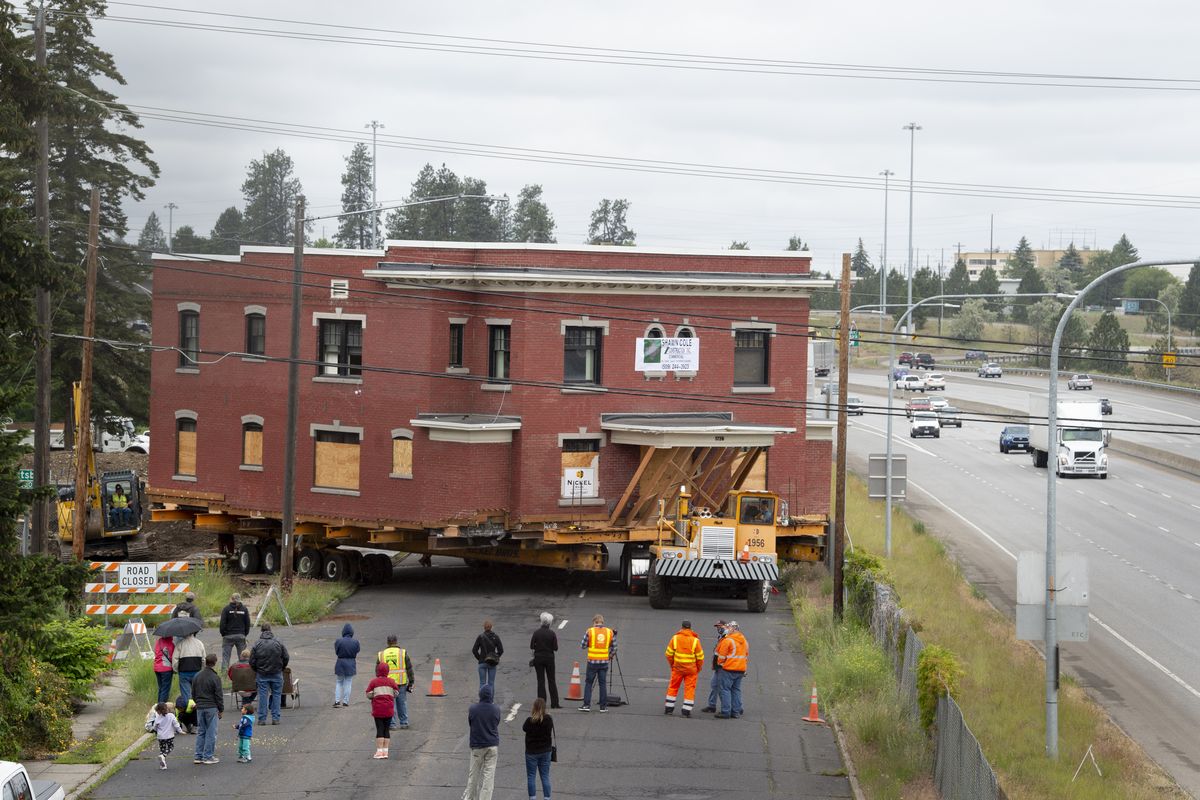 The two-story Rose Apartments building inches slowly off its foundation and onto Third Avenue before it heads to Fourth Avenue and a new foundation in East Central Spokane. It took most of the day Tuesday, June 16, 2020 to move the massive building.  (JESSE TINSLEY)