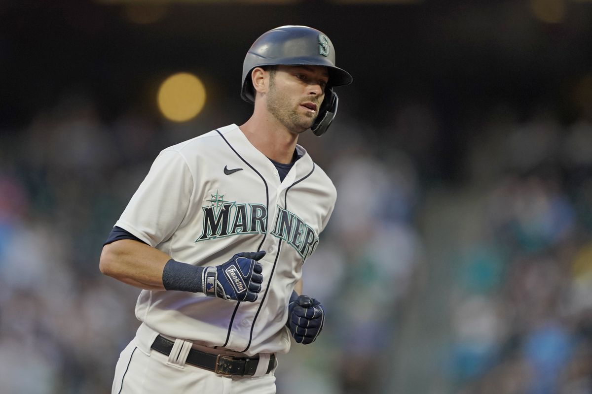 Seattle Mariners' Mitch Haniger, right, is greeted by Ty France