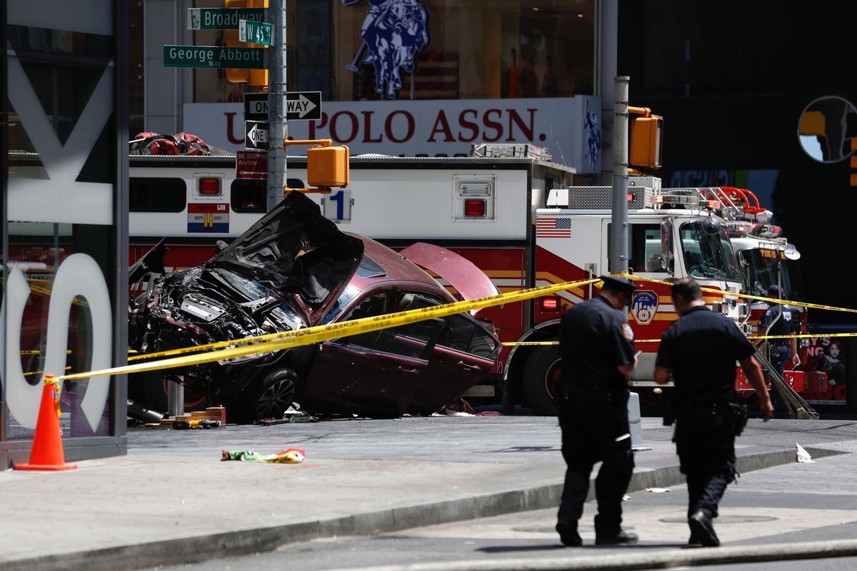 FILE- A smashed car sits on the corner of Broadway and 45th Street in New York
