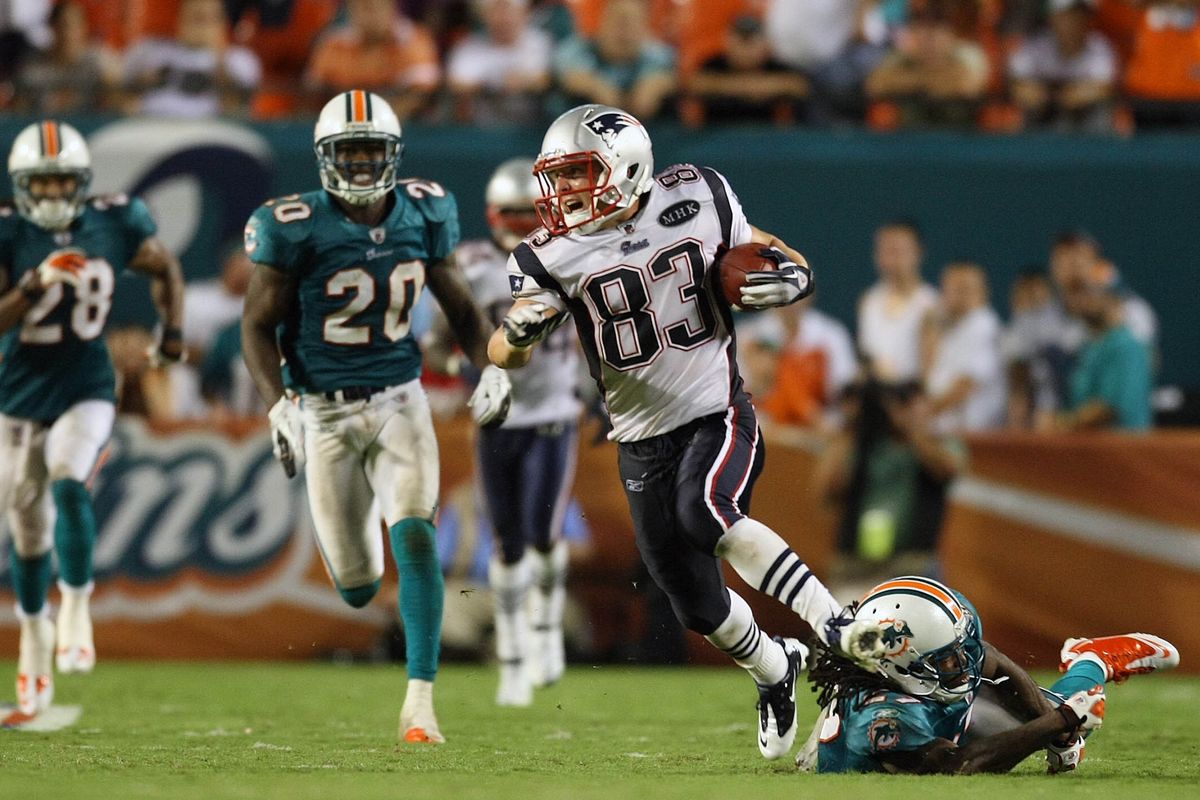 New England wide receiver Wes Welker gets away from Miami defenders on a game-breaking 99-yard pass-and-run touchdown play. (Associated Press)