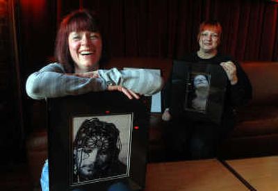 
Photographer Bethany Mahan, left, sits with one of her subjects, Elizabeth Sandoval, and some of her work at a downtown restaurant where her work was displayed. Mahan met Sandoval while walking around Spokane and took the photo Sandoval is holding.  
 (Jesse Tinsley / The Spokesman-Review)