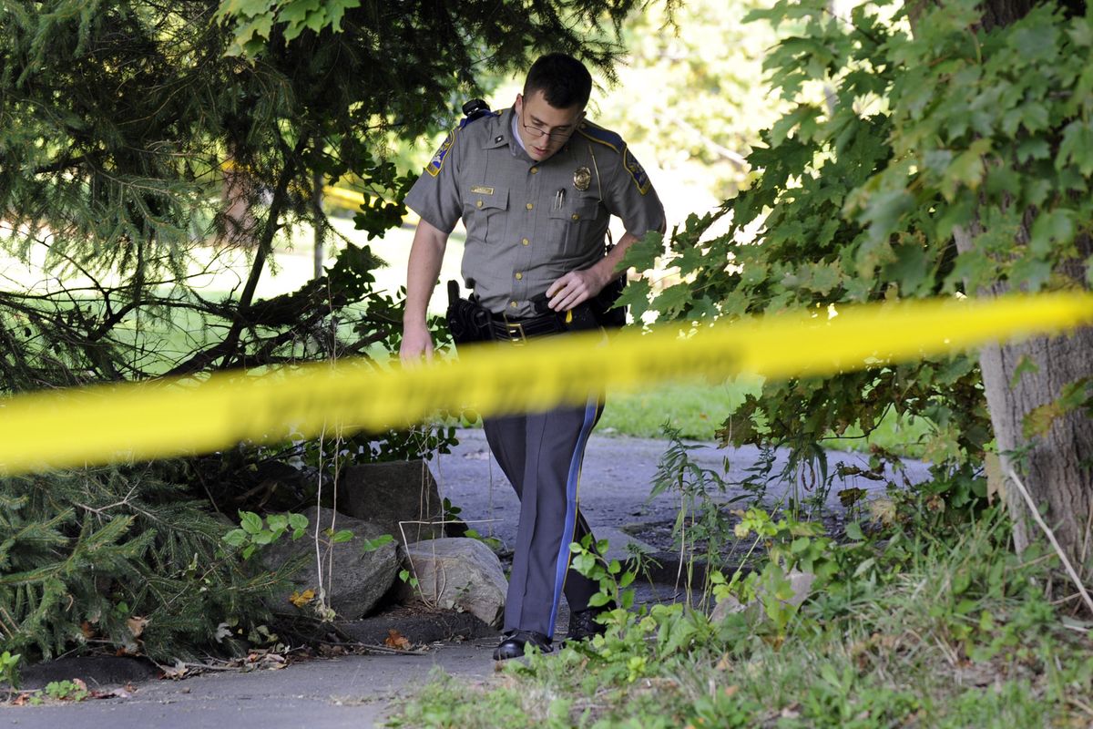 State Trooper Matt Losh emerges from the backyard of a home on Meeting House Hill Circle in New Fairfield, Conn., where a fatal shooting took place, Thursday, Sept. 27, 2012. A Connecticut man fatally shot a masked teenager in self-defense during what appeared to be an attempted burglary early Thursday morning, then discovered that he had killed his son, state police said. (Carol Kaliff / The News-times)