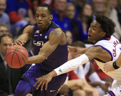 Kansas State guard Barry Brown, left, is covered by Kansas guard Devonte' Graham during the first half of an NCAA college basketball game in Lawrence, Kan., Tuesday, Jan. 3, 2017. (Orlin Wagner / Associated Press)