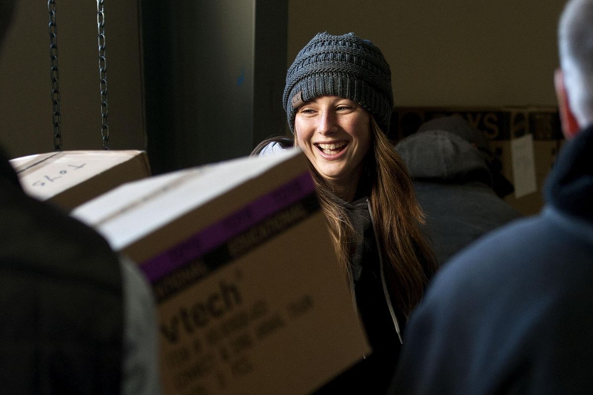 Freeman High School senior Marley Pratt helps move boxes of toys at the Christmas Bureau at Spokane County Fairgrounds on Wednesday, Dec. 6, 2017. (Kathy Plonka / The Spokesman-Review)