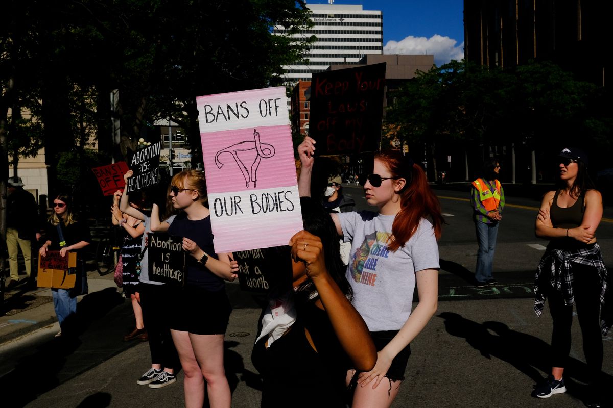 Isabella Senteno, center, of Spokane, holds a “Bans Off Our Bodies” sign during a protest against the Supreme Court’s decision to overturn Roe v. Wade on Friday, Jun 24, 2022, in Spokane, Wash.  (Tyler Tjomsland/The Spokesman-Review)
