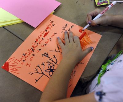 Lillian Parsons, 8, makes a thank-you card Saturday at the Imagination Space at The Citadel mall in Colorado Springs, Colo., for the firefighters fighting the Waldo Canyon fire. (Associated Press)