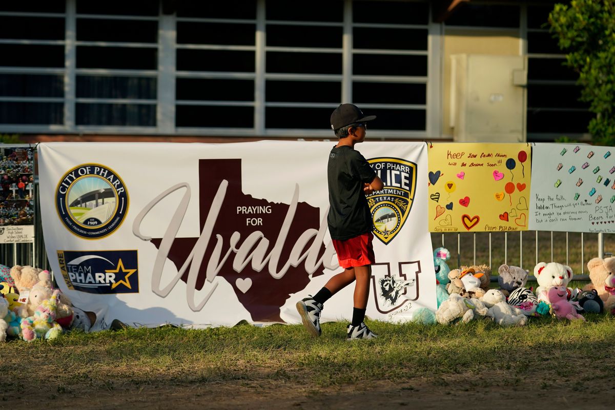 A boy walks June 3 along a memorial outside Robb Elementary School created to honor the victims killed in last week’s school shooting in Uvalde, Texas.  (Eric Gay)