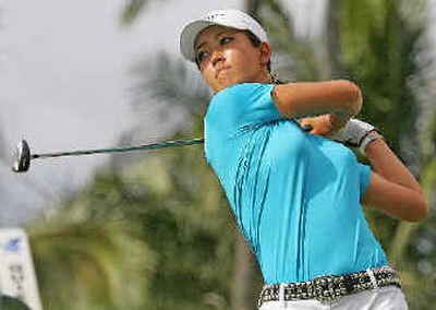 
Michelle Wie tees off the 15th tee en route to a 75 at the Sony Open.
 (Associated Press / The Spokesman-Review)