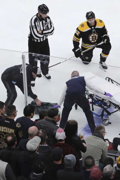 Boston Bruins right wing David Backes, right, watches as medical workers attend to Ottawa Senators right wing Scott Sabourin, who was injured on a play with Backes, during the first period of an NHL hockey game in Boston, Saturday, Nov. 2, 2019. (Charles Krupa / Associated Press)