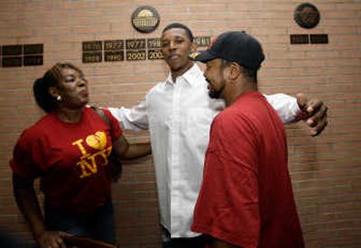 
Nick Young, center, shown embracing his parents, is expected to be a high pick in Thursday's NBA draft. Associated Press
 (Associated Press / The Spokesman-Review)