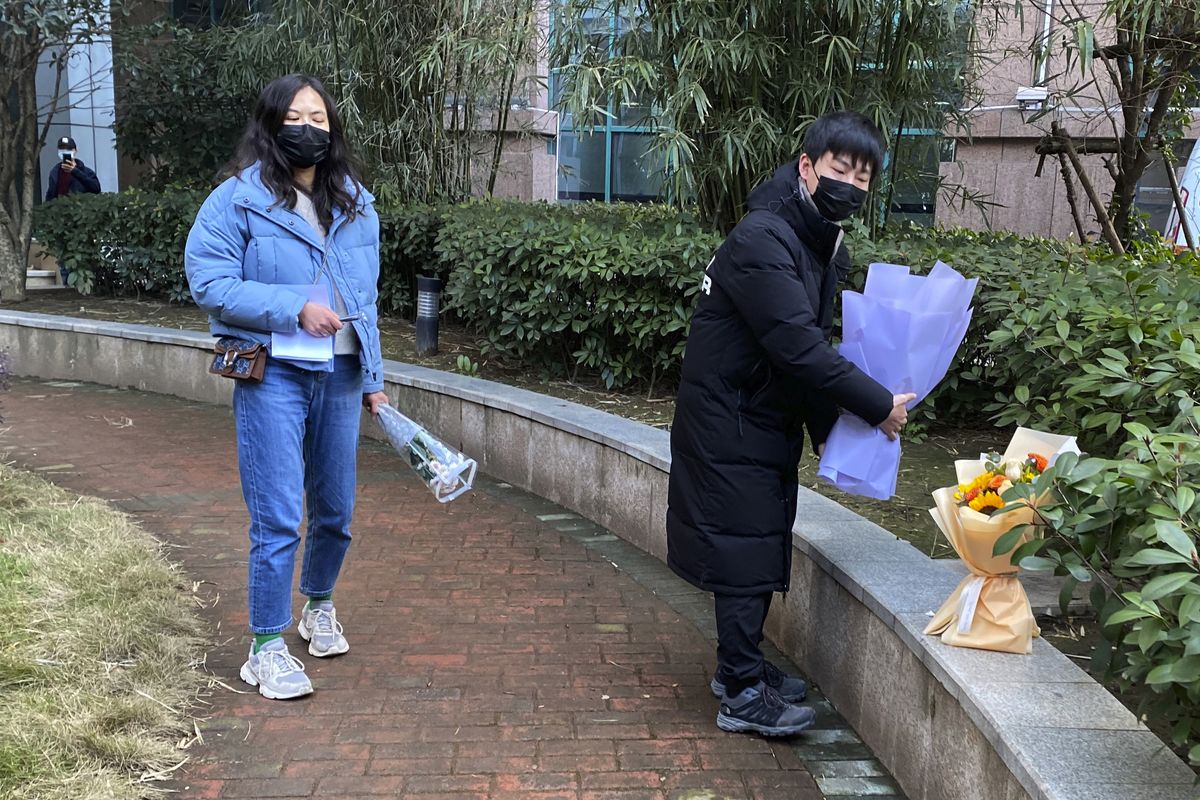 Residents visiting the Wuhan Central Hospital offer flowers in memory of Li Wenliang, the whistleblower doctor who sounded the alarm and was reprimanded by local police for it in the early days of Wuhan