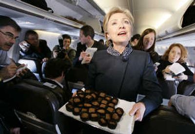 
Sen. Hillary Rodham Clinton passes out chocolates to the press corps aboard her plane Thursday. Associated Press
 (Associated Press / The Spokesman-Review)
