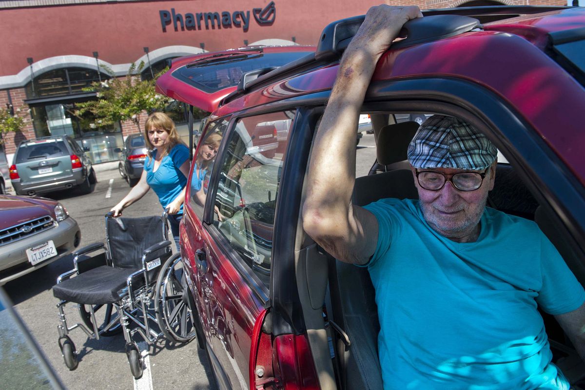 Jeris Baker, left, gets the wheelchair for her father, John Hill, while they shop in Davis, Calif.