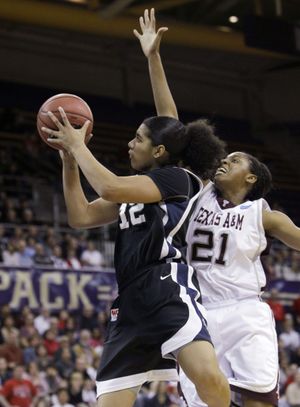 Gonzaga's Vivian Frieson, left, drives in front of Texas A&M's Adaora Elonu in the first half during an NCAA second-round college basketball game Monday, March 22, 2010, in Seattle. (Elaine Thompson / Associated Press)