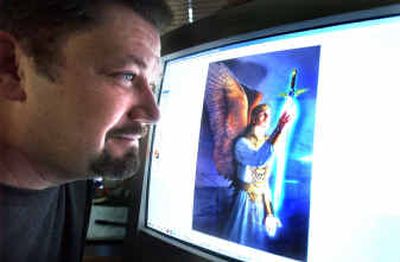 
Ralph Bagley, president and CEO of N'Lightning, a Christian video game software development company, poses with an image from one of his company's games. 
 (Associated Press / The Spokesman-Review)